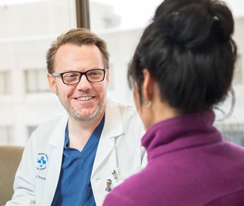 Dr. Mark Walker speaks to a patient